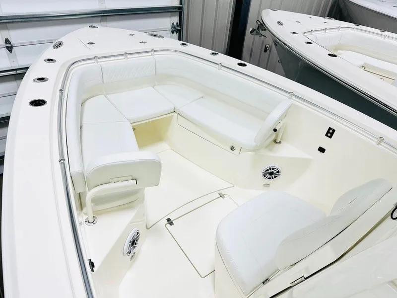 Slide: The Image of 2024 Cobia 280 CC boat interior with white seating and modern design. - 5
