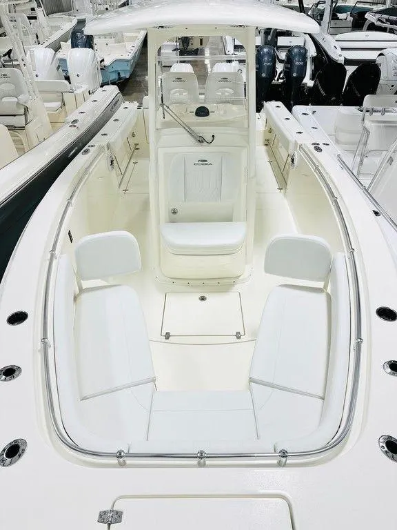 Slide: The Image of 2024 Cobia 280 CC boat interior with white seating and modern design. - 7