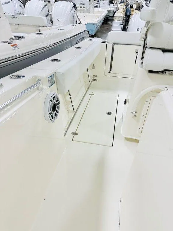 Slide: The Image of 2024 Cobia 280 CC boat interior with seating and storage compartments. - 9