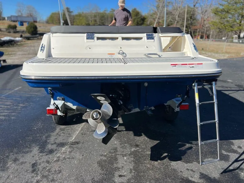 Slide: The Image of 2019 Bayliner VR6 Bowrider I/O boat rear view with propeller and ladder. - 13