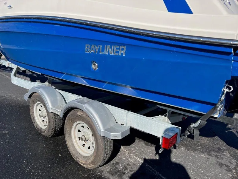 Slide: The Image of 2019 Bayliner VR6 Bowrider I/O on trailer, blue hull, parked outdoors. - 3