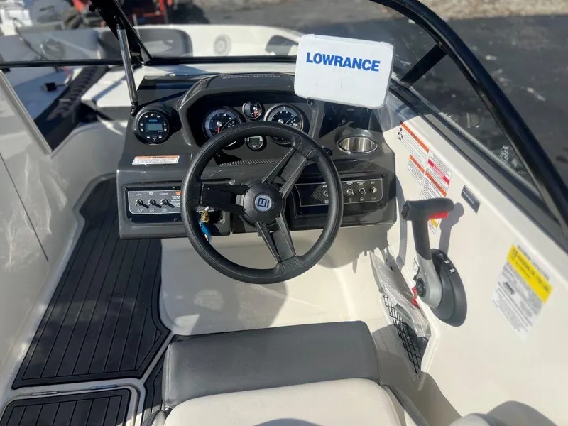 Slide: The Image of 2019 Bayliner VR6 Bowrider I/O dashboard with steering wheel and Lowrance display. - 7