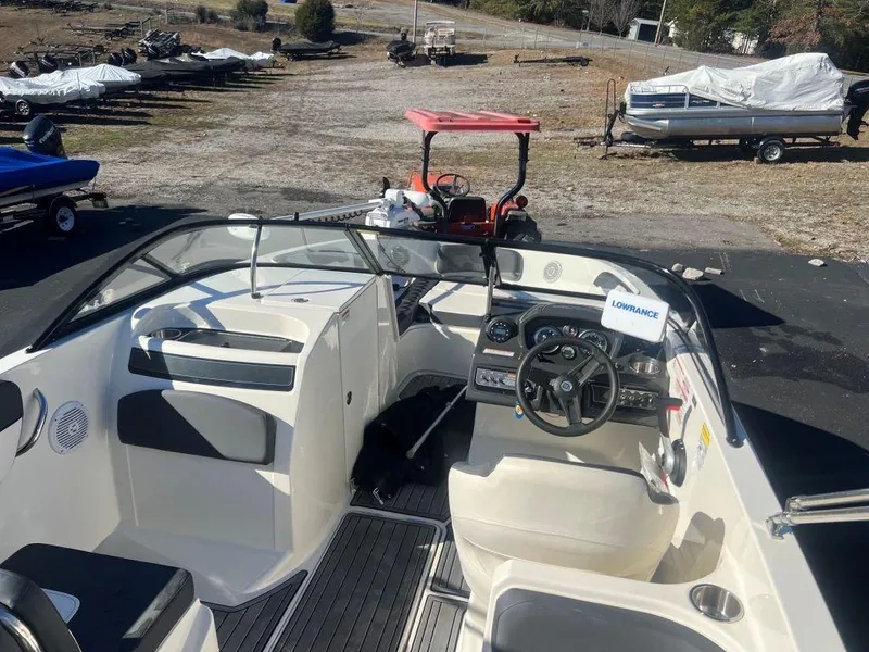 Slide: The Image of 2019 Bayliner VR6 Bowrider I/O interior with steering wheel and seating area. - 9
