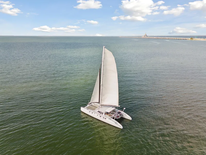 Slide: The Image of Sailing catamaran Technologie Marine Entincelle 60, 1999, on open sea under clear sky. - 15