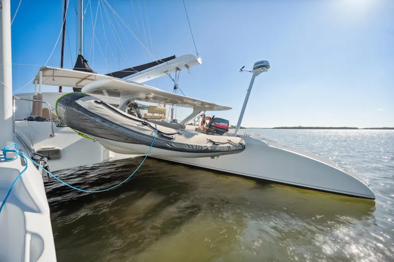Slide: The Image of 1999 Technologie Marine Entincelle 60 trimaran on calm waters under clear blue sky. - 16