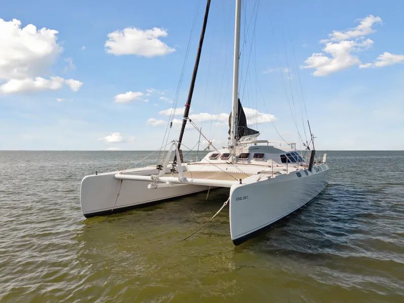 Slide: The Image of Catamaran Technologie Marine Entincelle 60, 1999 model, sailing on calm waters under a blue sky. - 2