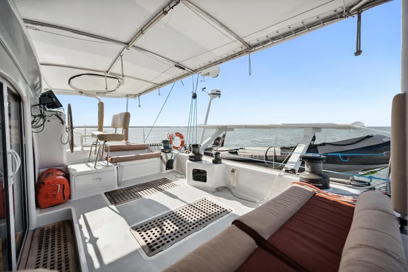 Slide: The Image of Spacious deck of 1999 Technologie Marine Entincelle 60 catamaran with seating and ocean view. - 25