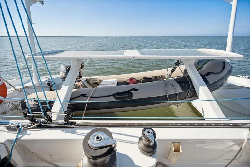 Slide: The Image of Sailing catamaran Technologie Marine Entincelle 60, 1999, with dinghy on deck, ocean view. - 29