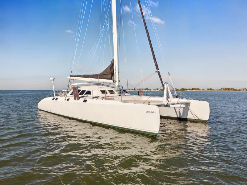 Slide: The Image of Catamaran Technologie Marine Entincelle 60, 1999 model, sailing on calm waters under clear skies. - 3