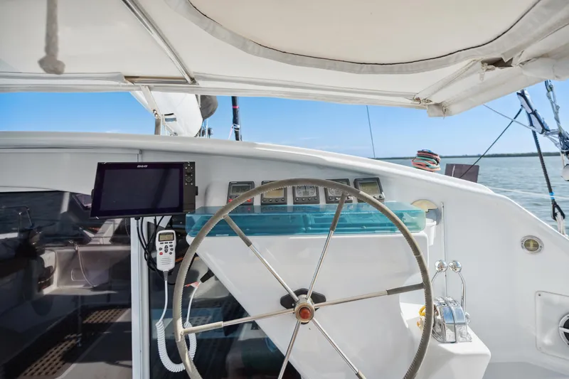 Slide: The Image of Steering wheel of a 1999 Technologie Marine Entincelle 60 yacht, featuring navigation equipment. - 37