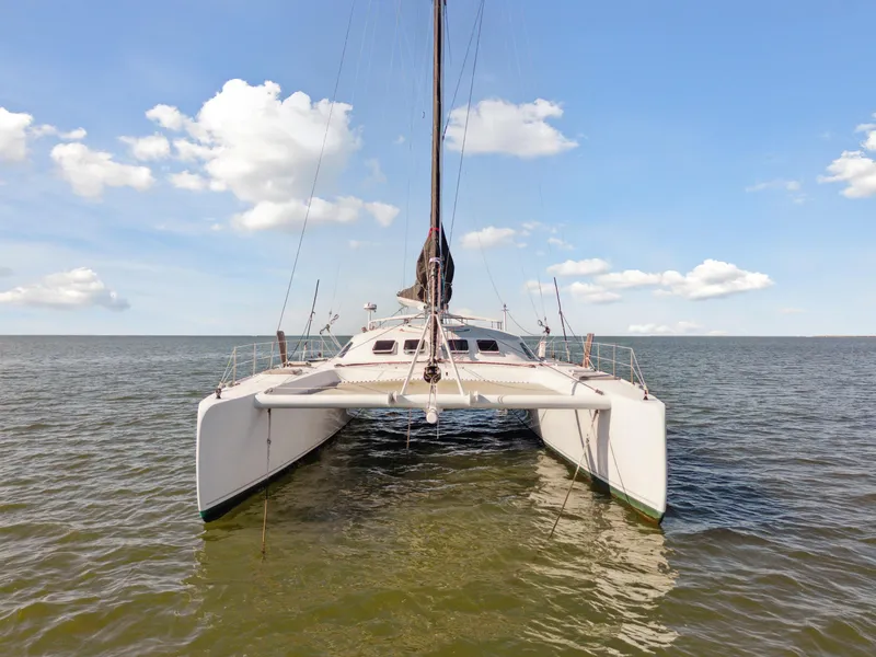 Slide: The Image of Catamaran Technologie Marine Entincelle 60, 1999 model, sailing on calm sea under blue sky. - 4