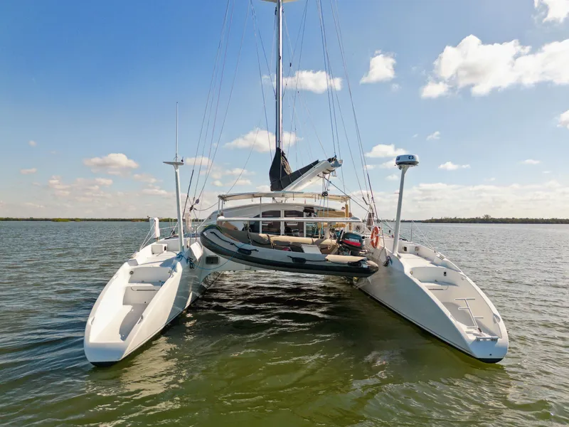 Slide: The Image of 1999 Technologie Marine Entincelle 60 catamaran on calm water under blue sky. - 5