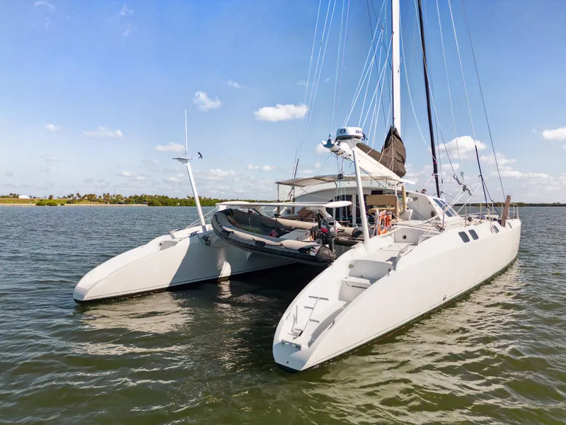 Slide: The Image of Trimaran Technologie Marine Entincelle 60, 1999 model, anchored on calm waters. - 6