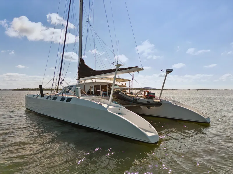 Slide: The Image of Catamaran Technologie Marine Entincelle 60, 1999 model, sailing on calm waters under a clear sky. - 7