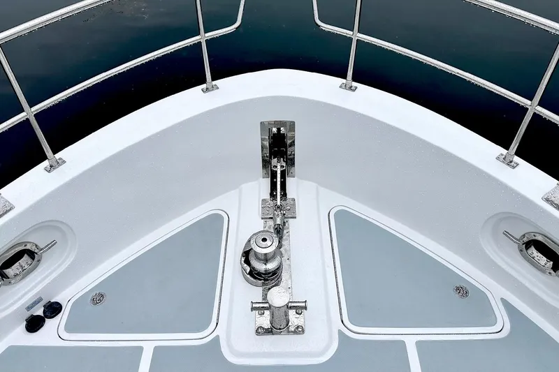 Slide: The Image of Helmsman Trawlers 46 Pilothouse 2026 bow deck with anchor system and railings. - 16