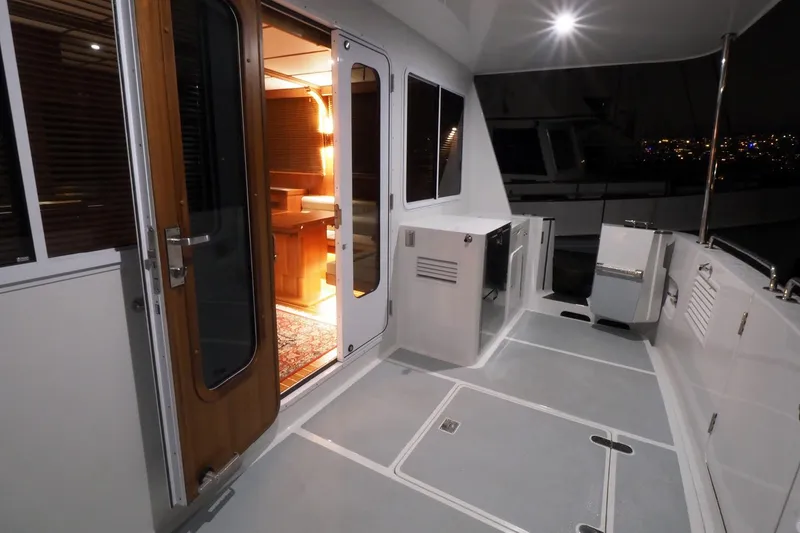 Slide: The Image of Helmsman Trawlers 46 Pilothouse 2026 yacht deck with illuminated interior view. - 19