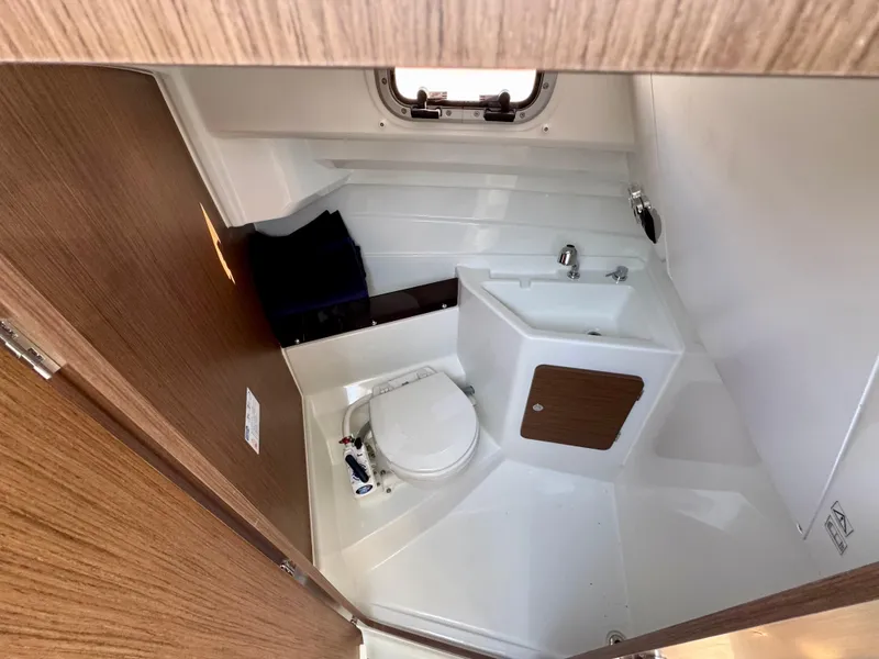 Slide: The Image of 2025 Beneteau Antares 8 boat bathroom with toilet and sink. - 11