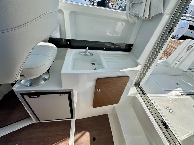 Slide: The Image of Interior of 2025 Beneteau Antares 8, featuring a compact sink and seating area. - 7