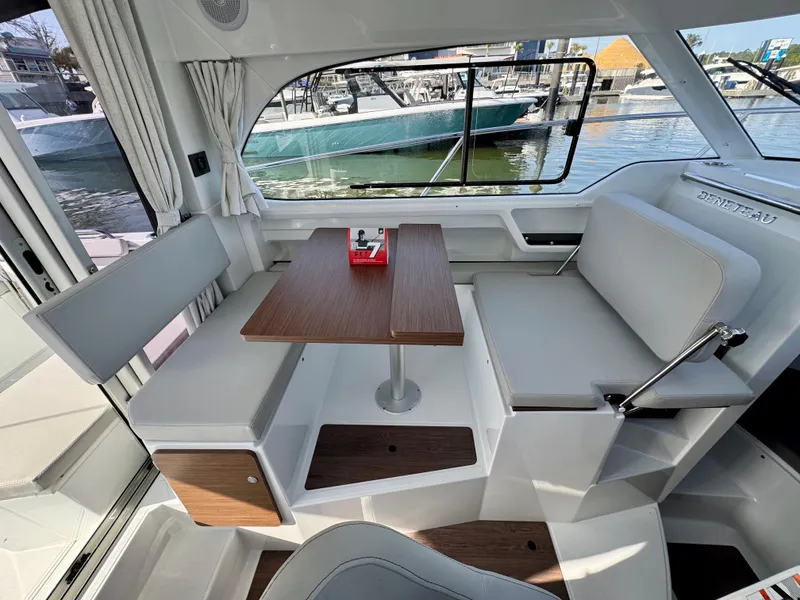 Slide: The Image of 2025 Beneteau Antares 8 interior with dining area and waterfront view. - 8