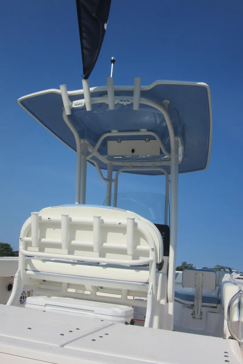Slide: The Image of 2023 Robalo R230 Center Console boat with T-top against blue sky. - 36