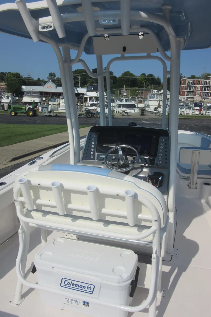 Slide: The Image of 2023 Robalo R230 Center Console boat with helm and seating, docked at marina. - 37
