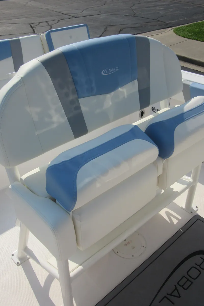 Slide: The Image of 2023 Robalo R230 Center Console boat seating with blue and white cushions. - 39