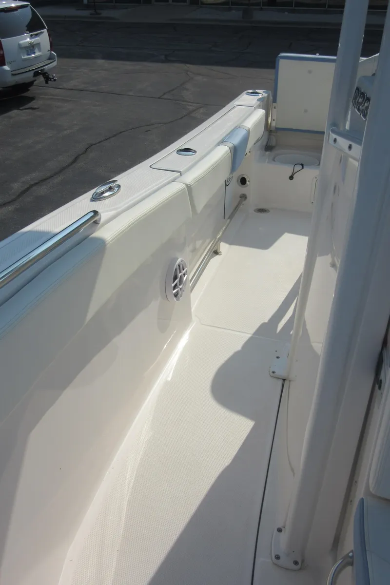 Slide: The Image of 2023 Robalo R230 Center Console boat deck, sleek design, spacious walkway. - 40