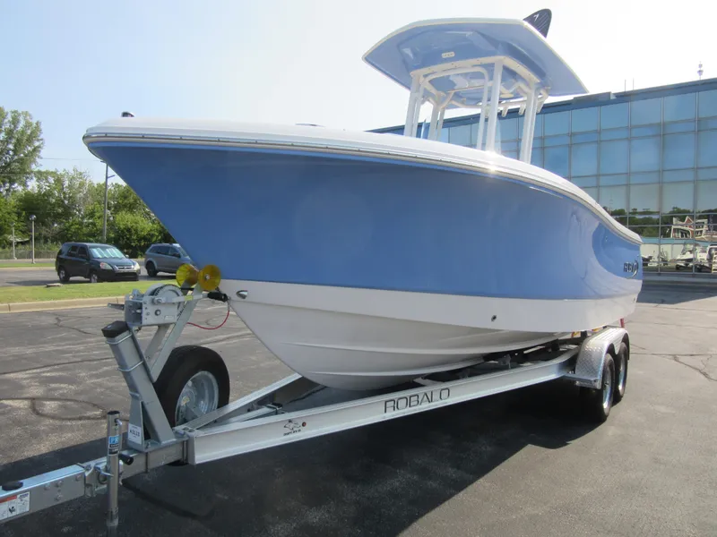 Slide: The Image of 2023 Robalo R230 Center Console boat on trailer, blue and white design. - 6