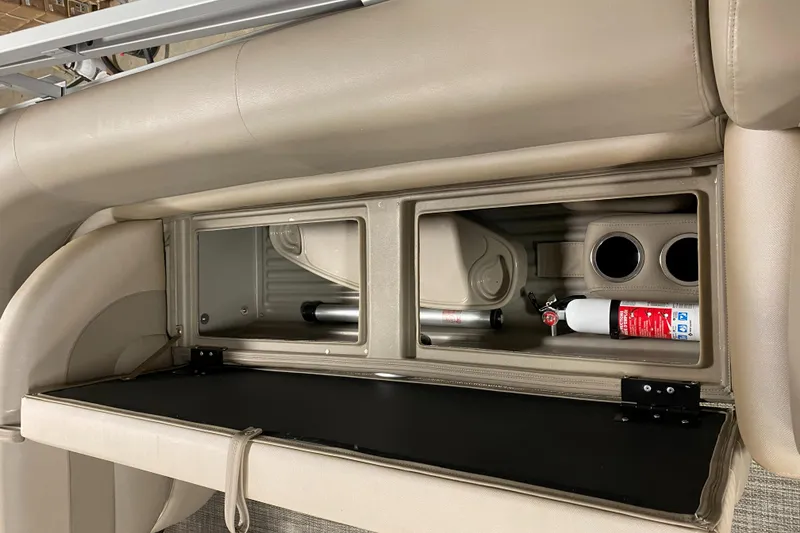 Slide: The Image of Interior storage compartments of 2022 Ranger 200C boat with fire extinguisher and cup holders. - 12
