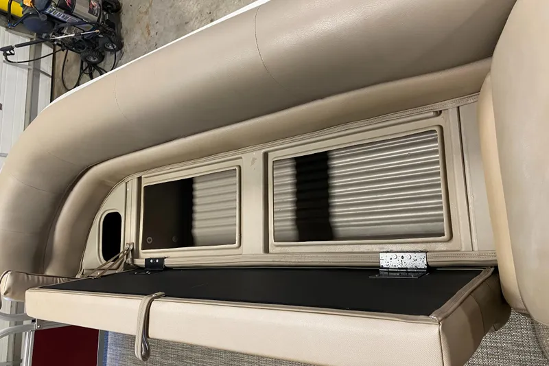 Slide: The Image of 2022 Ranger 200C boat interior with beige seating and storage compartments. - 14