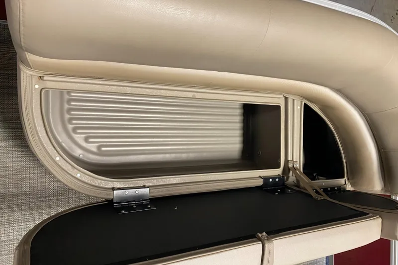 Slide: The Image of Open storage compartment in 2022 Ranger 200C boat with beige upholstery. - 15