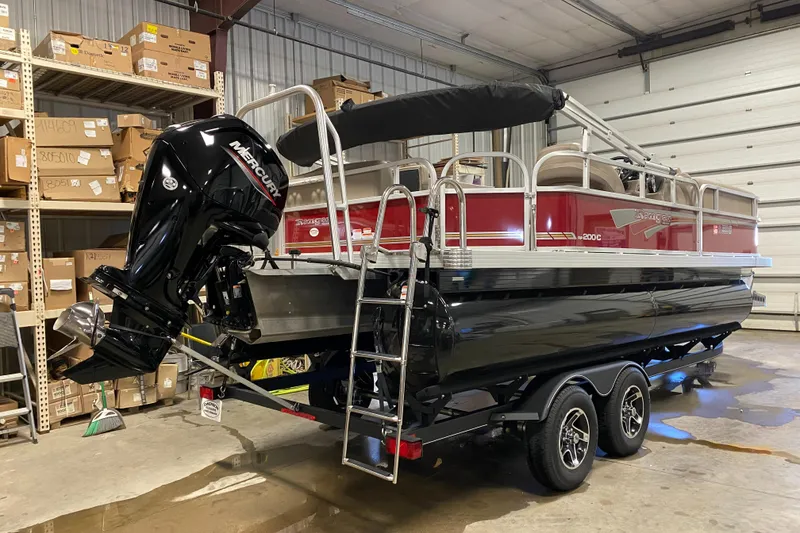 Slide: The Image of 2022 Ranger 200C pontoon boat in a garage, featuring a Mercury outboard motor. - 3