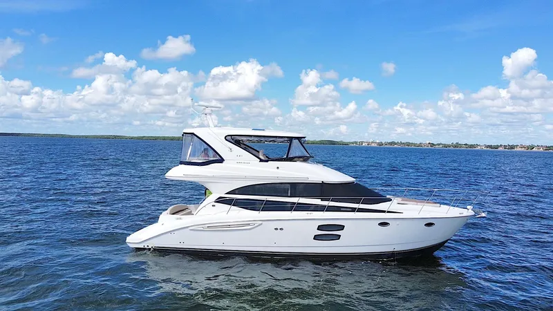 The Image of 2013 Meridian 441 Sedan yacht cruising on open water under a clear blue sky. - 0