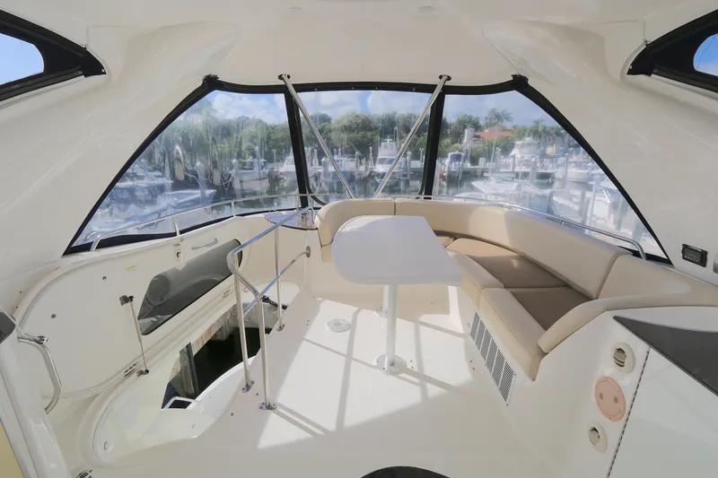 Slide: The Image of Interior of 2013 Meridian 441 Sedan yacht with seating and table, overlooking marina. - 12