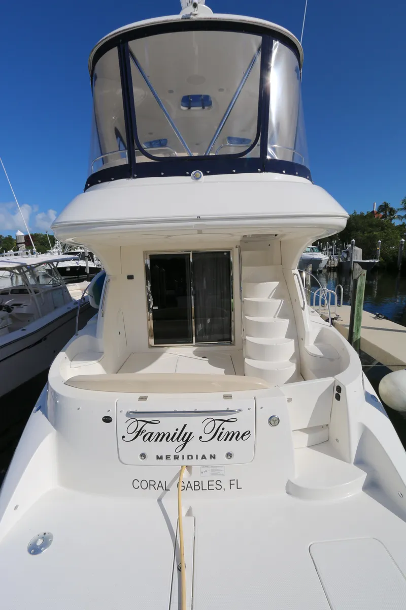 Slide: The Image of 2013 Meridian 441 Sedan yacht docked, featuring spacious deck and elegant design. - 13