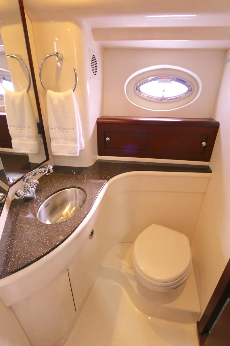 Slide: The Image of Luxurious bathroom in 2013 Meridian 441 Sedan yacht with sink, toilet, and porthole. - 9