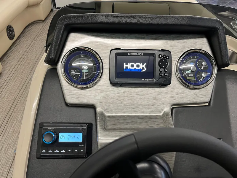 Slide: The Image of 2023 Premier 250 Sunsation boat dashboard with Lowrance Hook display and gauges. - 10