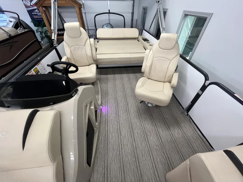 Slide: The Image of 2023 Premier 250 Sunsation boat interior with beige seating and modern flooring. - 5