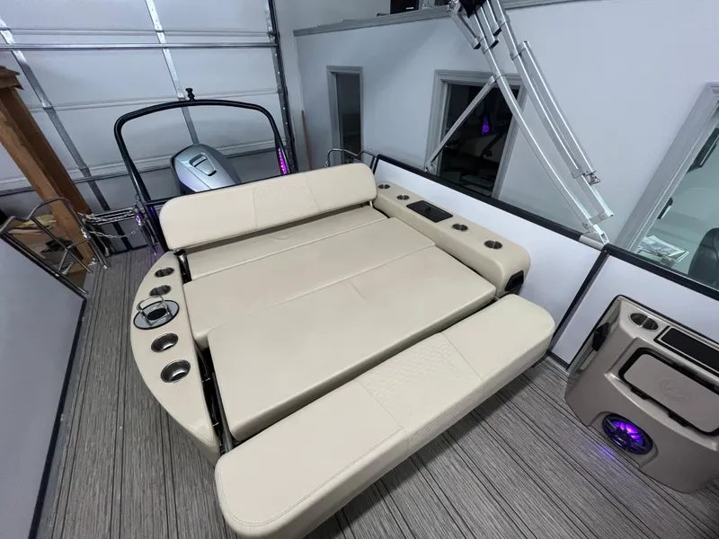 Slide: The Image of 2023 Premier 250 Sunsation boat interior with beige seating and cup holders. - 6