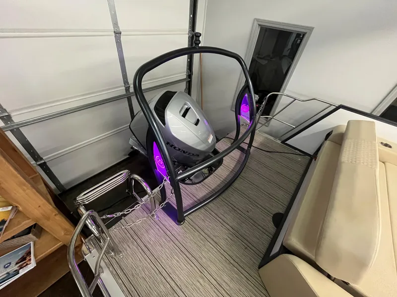 Slide: The Image of 2023 Premier 250 Sunsation boat with Honda outboard motor in a garage. - 8