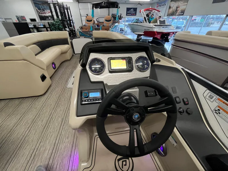 Slide: The Image of 2023 Premier 250 Sunsation boat interior with steering console and seating area. - 9