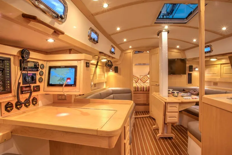 Slide: The Image of Luxurious interior of 2025 Tartan 395 yacht with modern navigation equipment and elegant wood finish. - 12