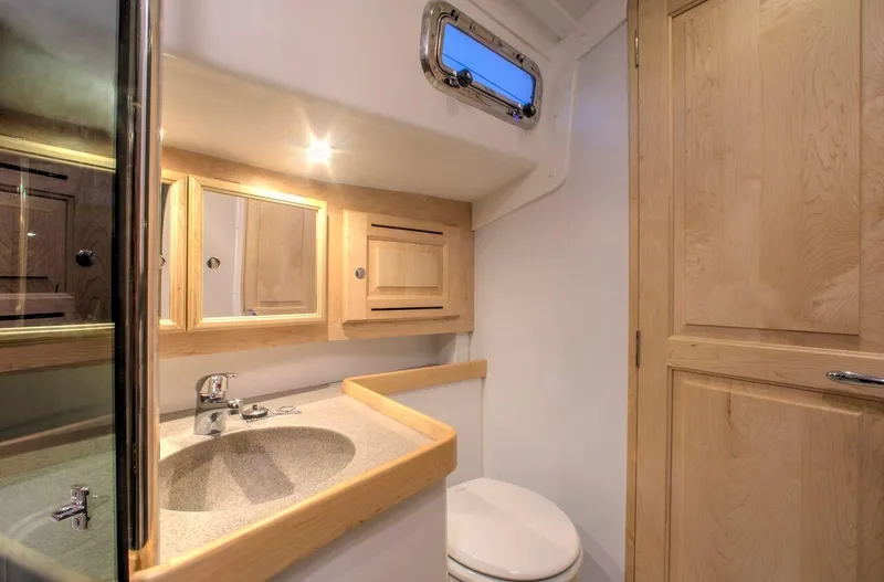 Slide: The Image of Modern bathroom interior in 2025 Tartan 395 yacht, featuring wooden cabinetry and compact design. - 6