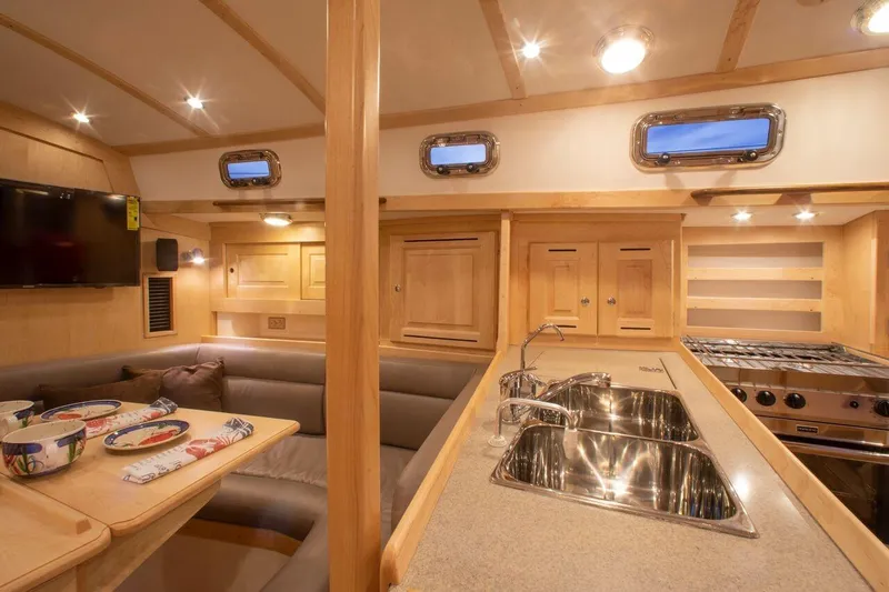 Slide: The Image of Luxurious interior of 2025 Tartan 395 yacht with modern kitchen and dining area. - 9