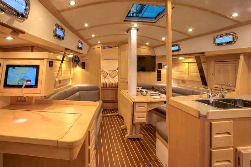 Slide: The Image of Luxurious interior of 2025 Tartan 395 yacht with modern amenities and elegant wood finish. - 15