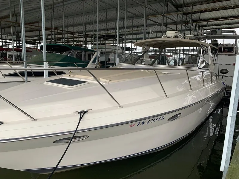 Slide: The Image of 1999 Regal 402 boat docked in a covered marina. - 10