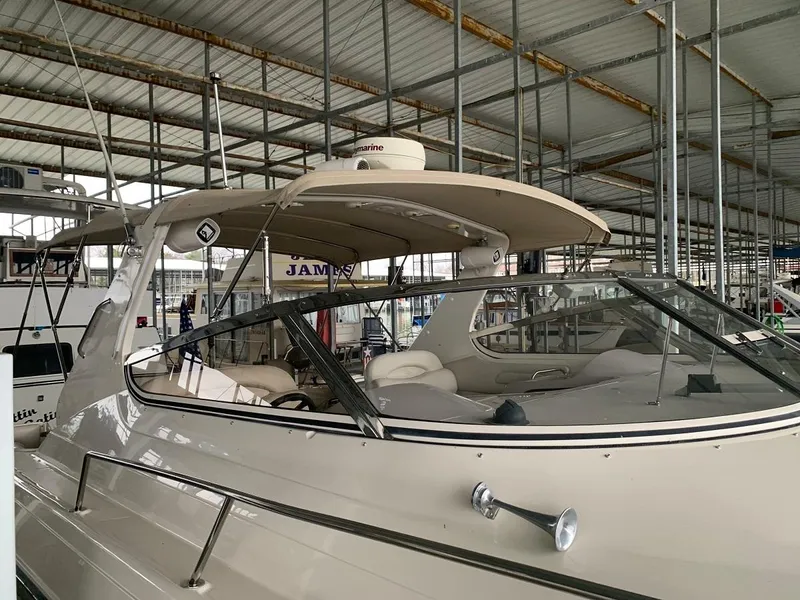 Slide: The Image of 1999 Regal 402 boat in marina, featuring sleek design and spacious interior. - 15