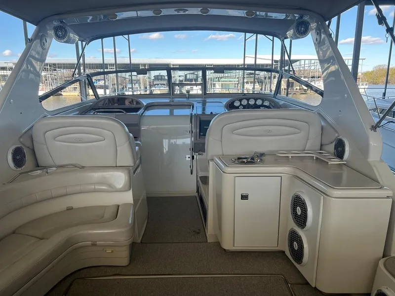 Slide: The Image of 1999 Regal 402 boat interior with plush seating and modern dashboard. - 18