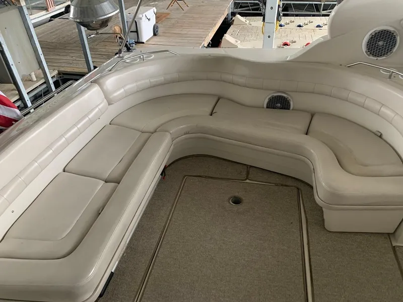 Slide: The Image of 1999 Regal 402 boat interior with beige leather seating and carpeted floor. - 20