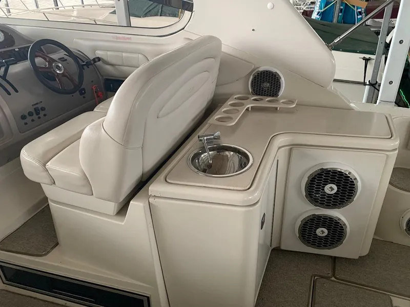 Slide: The Image of 1999 Regal 402 boat interior with seating, sink, and speaker system. - 22